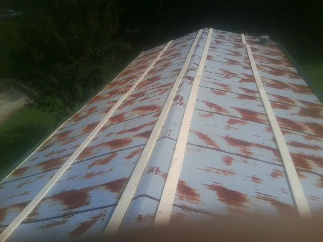 Rusted metal roof panels with new wood purlins before replacement — Storm Damage Roof Repair in Travelers Rest by Roofing Brothers